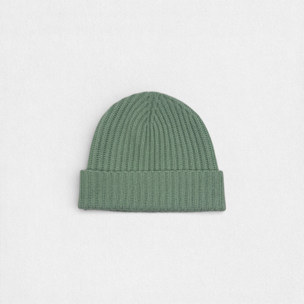 Green knit beanie on a light gray background