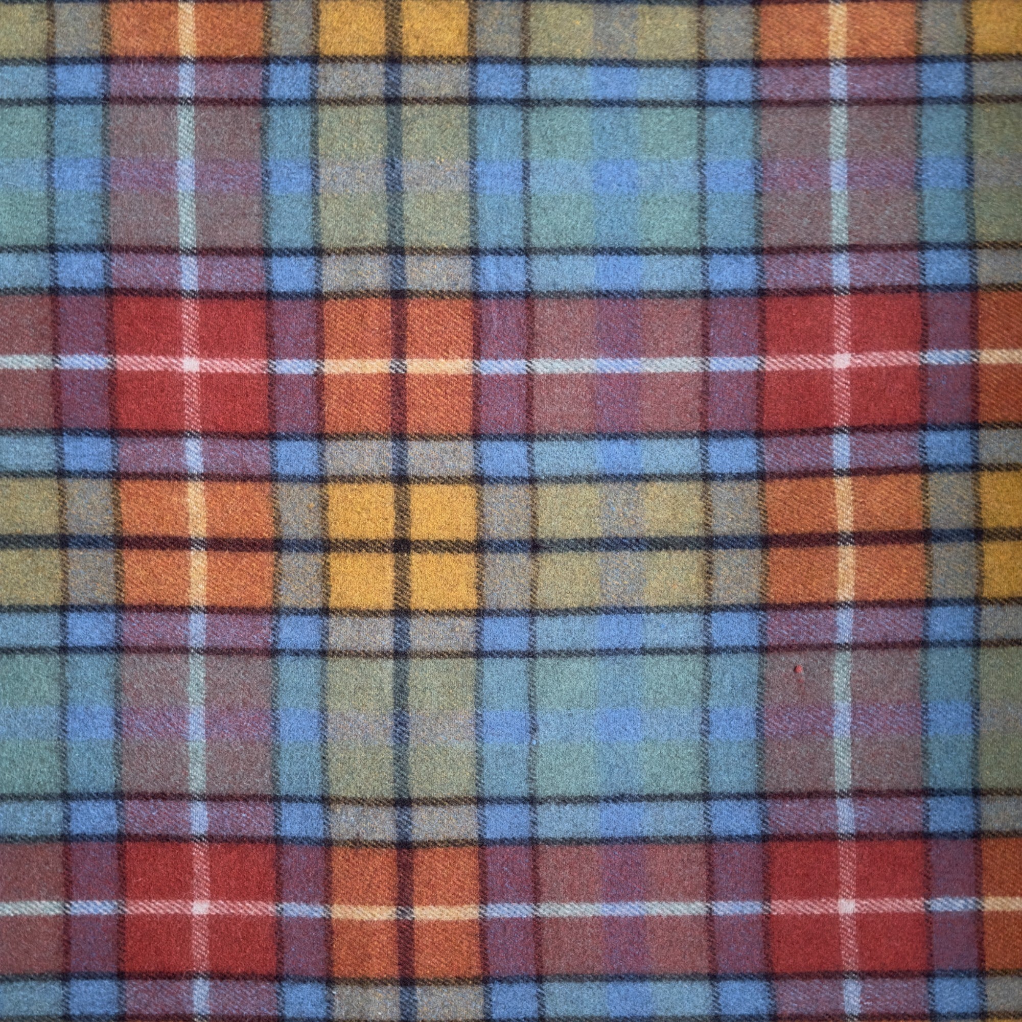 A close up example of the Antique Buchanan tartan, The Antique Buchanan tartan has orange, light blue and dark orange stripes in a checkered pattern.