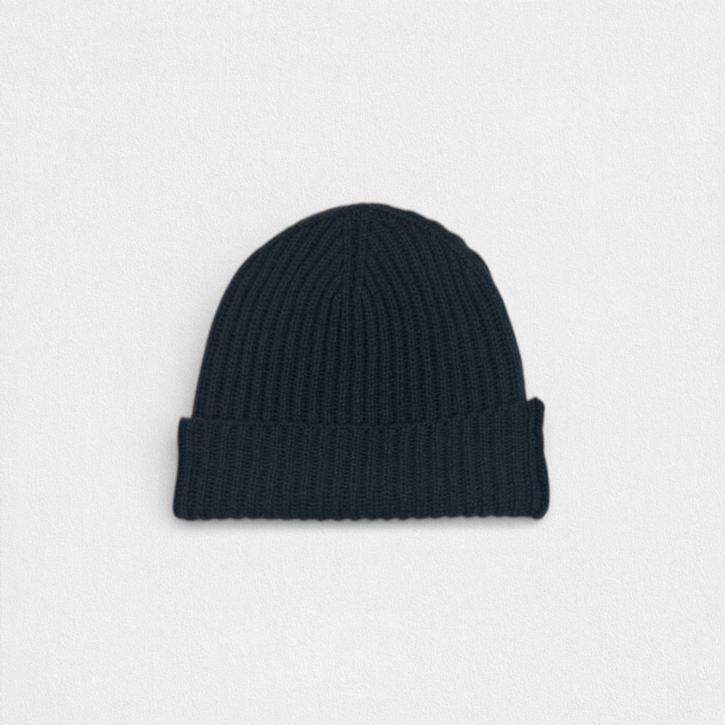 Dark charcoal ribbed cashmere beanie photographed on a white background.