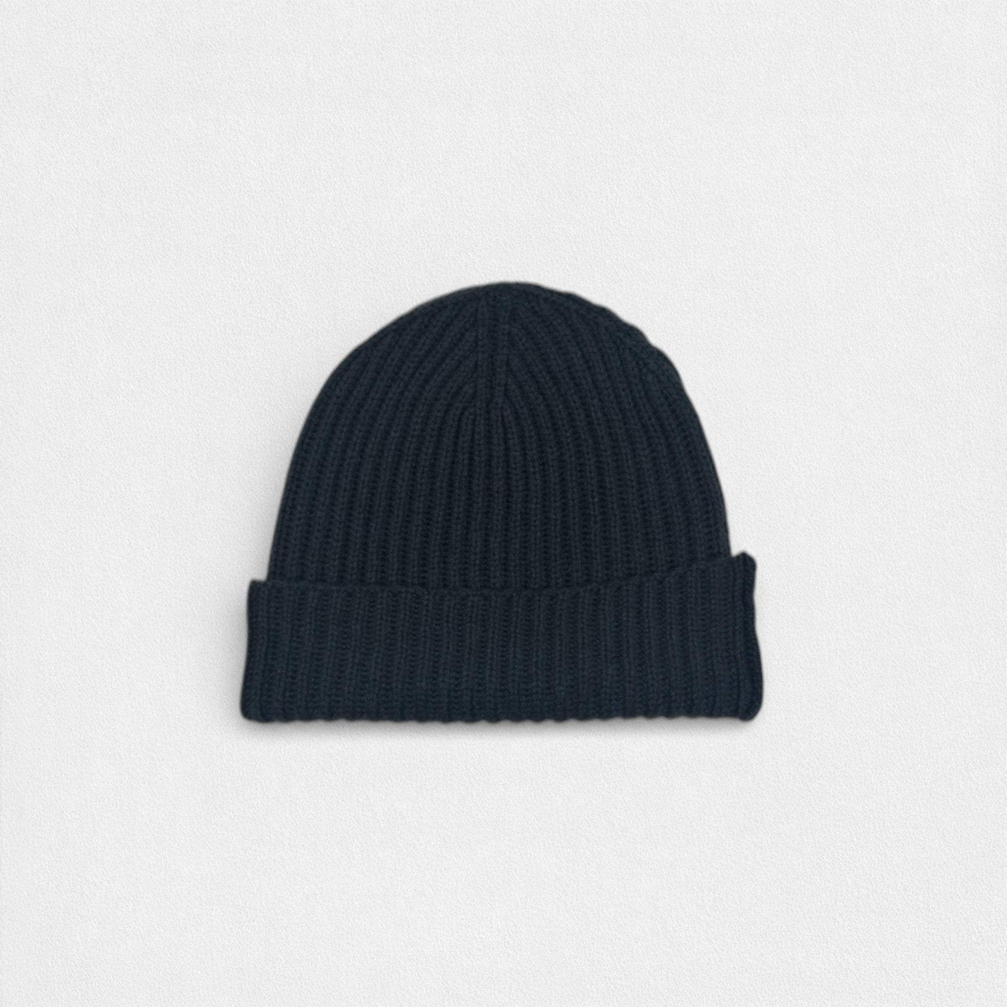 Dark charcoal ribbed cashmere beanie photographed on a white background.