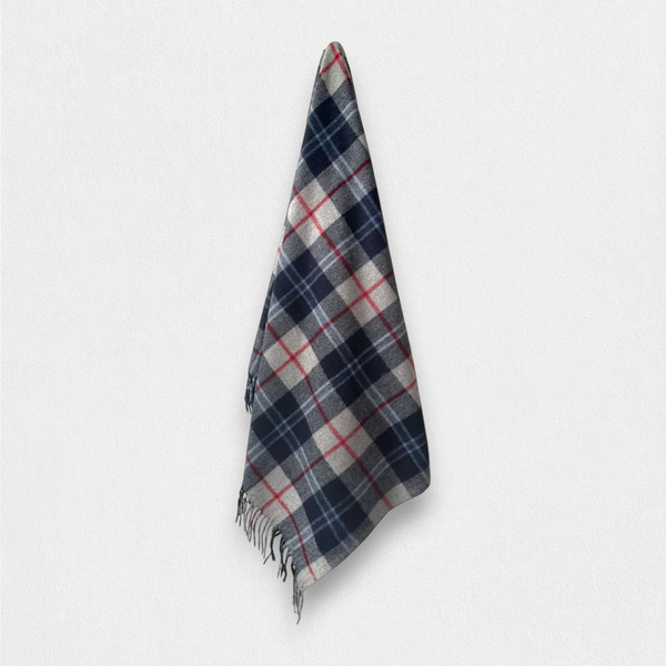 A Douglas Navy 100% recycled wool blanket, hanging from a wall hook against a white background.