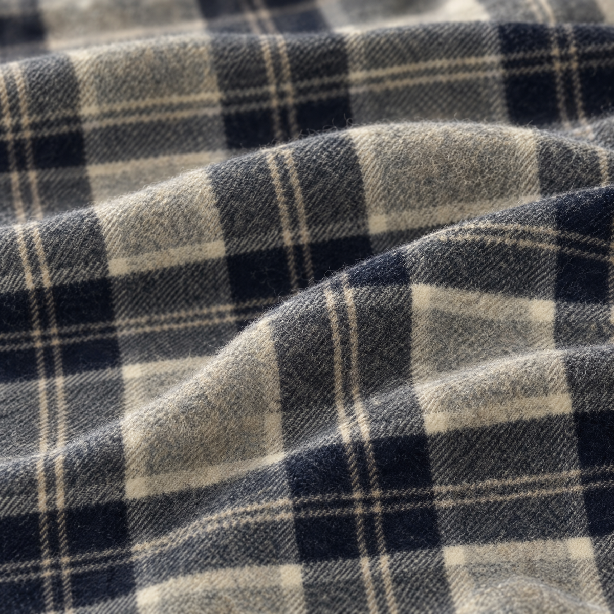 Close-up of the Silver Bannockbane tartan lambswool fabric, showing the weave in dark grey, light grey and navy. [swatch]