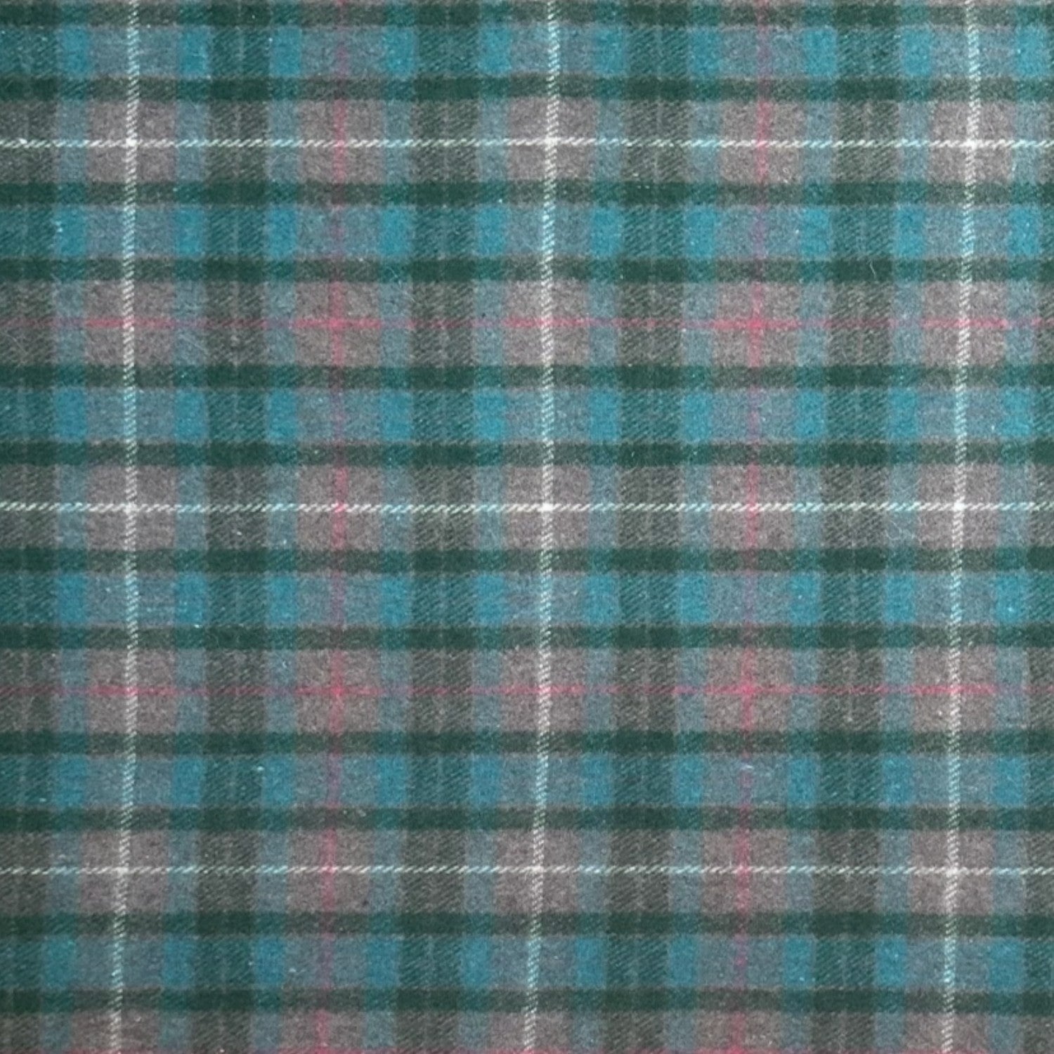 A close-up of a plaid fabric pattern with teal blue, dark green, pink, and white intersecting stripes.