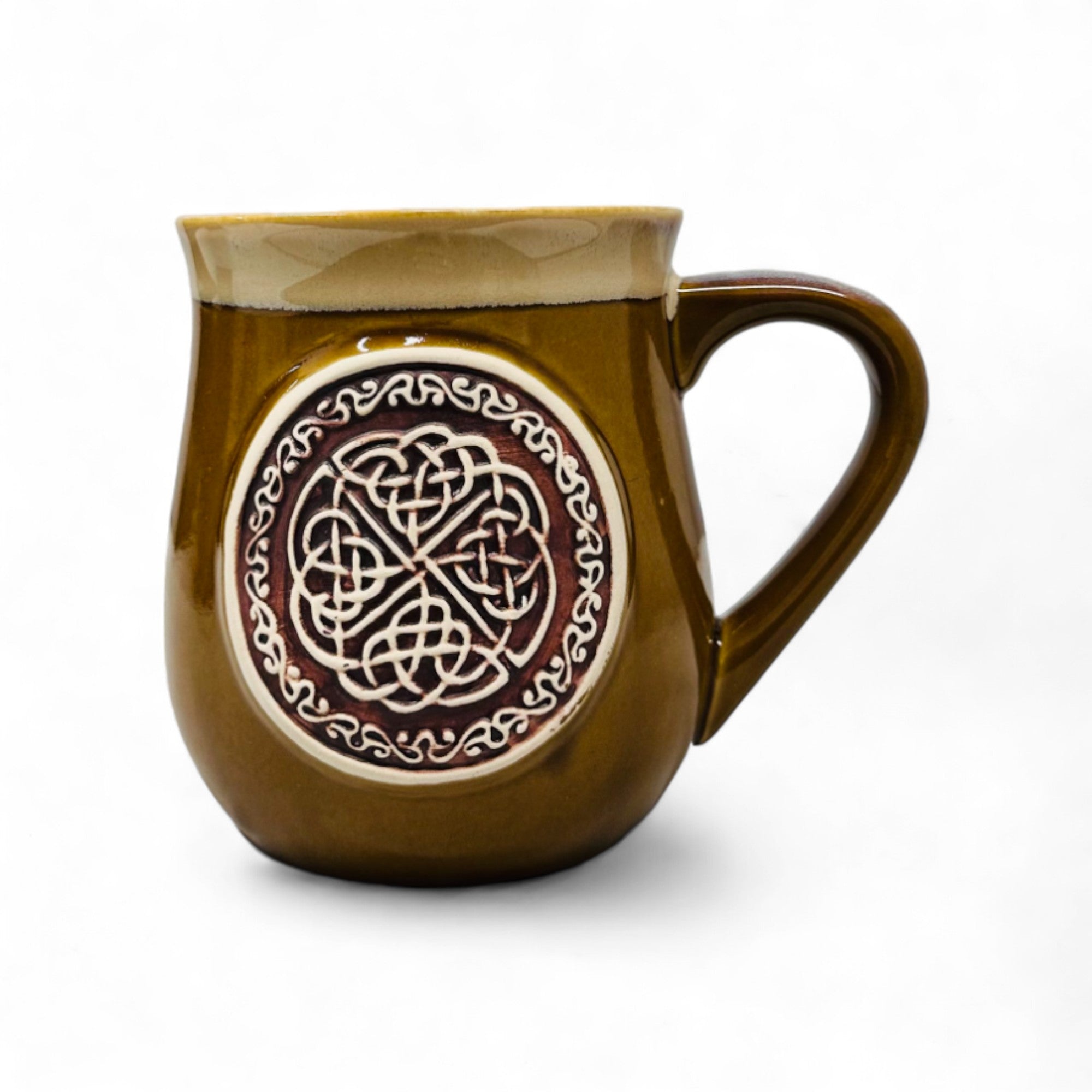 A stoneware mug with a Celtic circle pattern and a yellow enamel finish on the upper part.