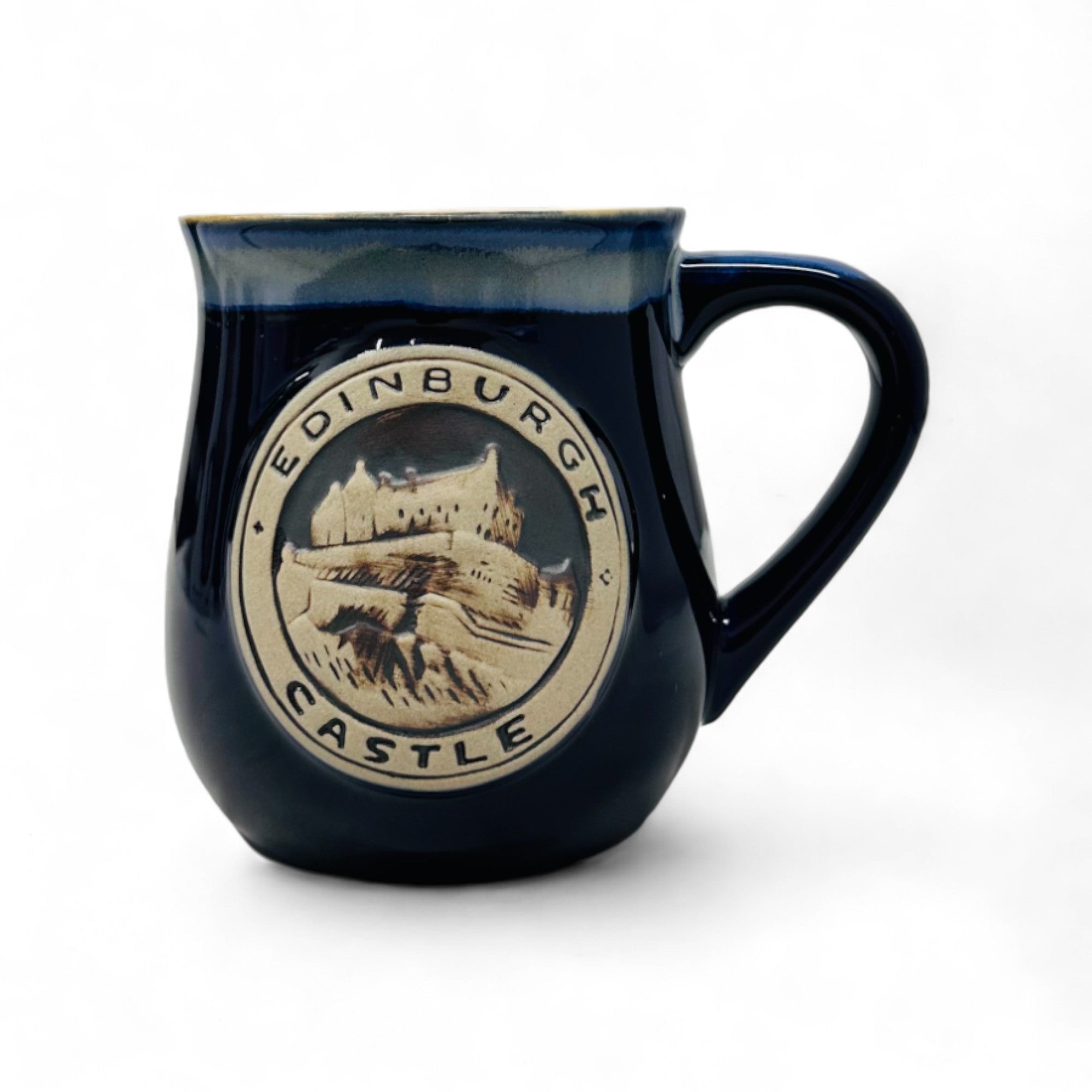 A blue stoneware mug with a detailed design of Edinburgh Castle in white and the text 'Edinburgh Castle' around the mug.