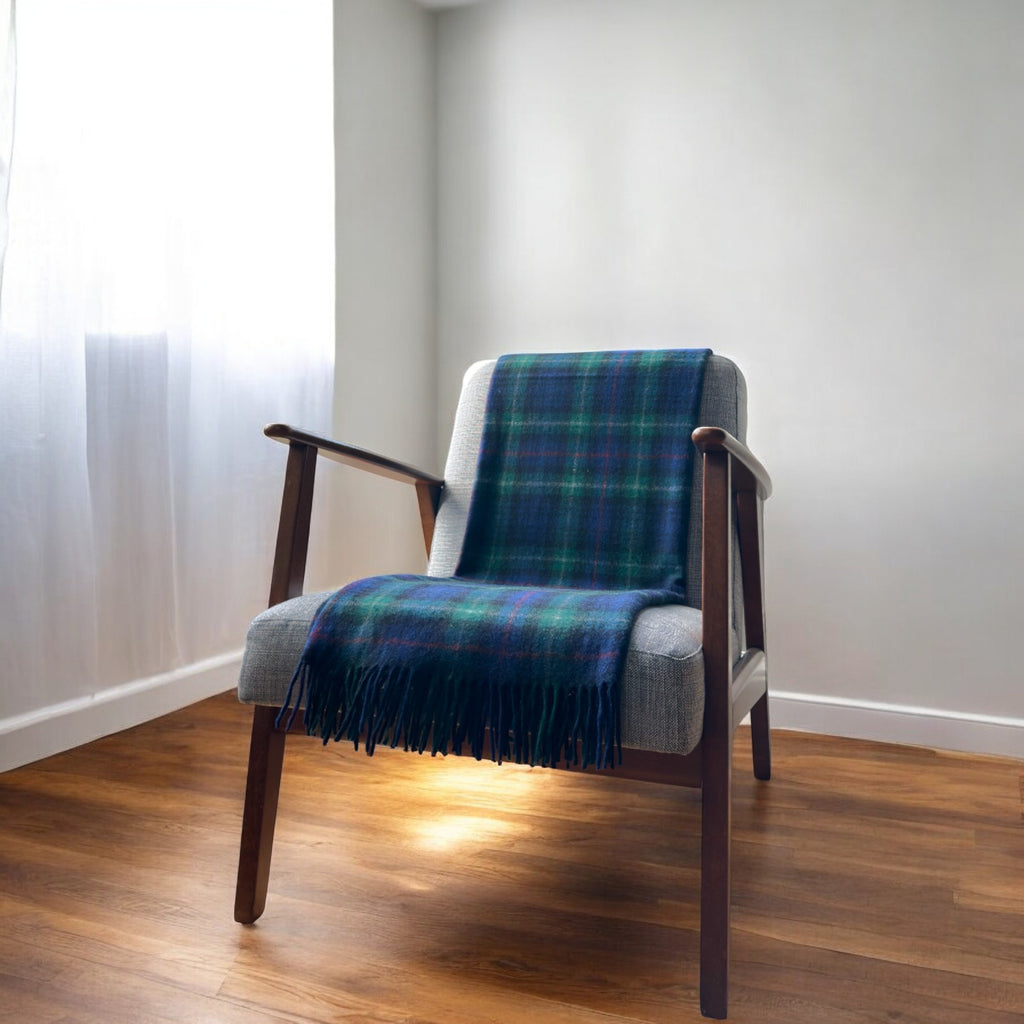 a mackenzie knee blanket draped over a chair in a cosy room