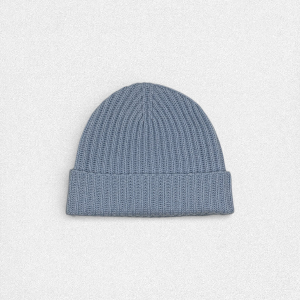 Blue knit beanie on a light gray background