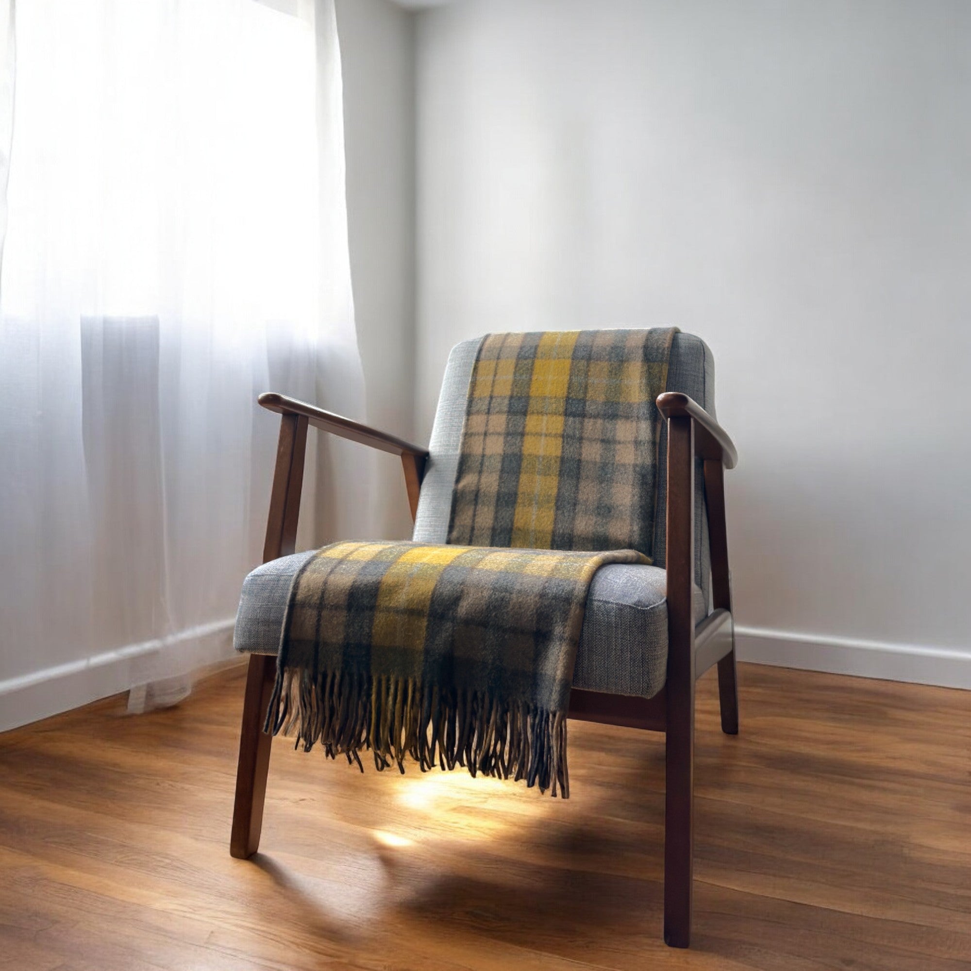 a natural buchanan recycled knee blanket draped over a chair in a cosy room