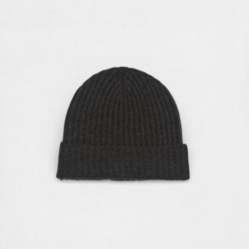 Black knit beanie on a light gray background