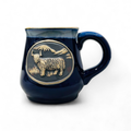 A blue Scottish stoneware mug with a detailed Highland Cow design in the center.