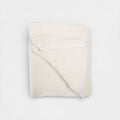 Folded white neck wrap on a light gray background