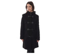 A woman standing outdoors wearing a black cashmere and wool duffle coat with a hood, featuring front pockets and classic toggles.